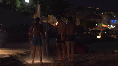 Men-taking-shower-at-the-beach