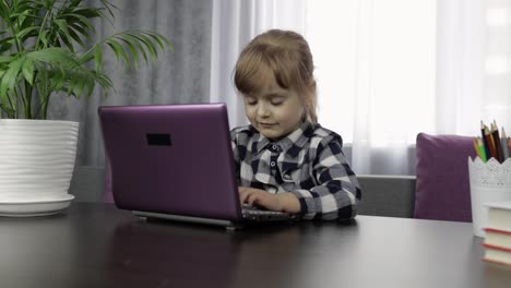 Girl-doing-online-homework-using-digital-laptop-computer.-Distance-education
