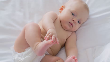 Lovely-baby-girl-of-six-months-in-diaper