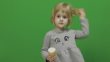 Kid-girl-eat-ice-cream-on-a-Green-Screen,-Chroma-Key