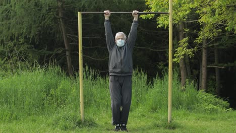 Active-senior-old-man-do-stretching-physical-exercises-in-coronavirus-quarantine
