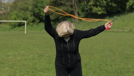 Active-senior-elderly-80-years-old-caucasian-woman-do-morning-physical-exercises