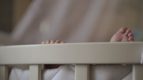 Baby-feet-outside-the-crib
