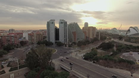 Flying-over-Valencia-at-sunset-Spain-Cityscape-with-bridge-and-buildings