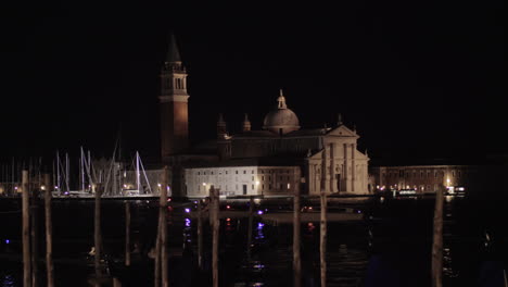 Night-Venice-with-boats-sailing-along-canal-overlooking-St-Marks-Campanile