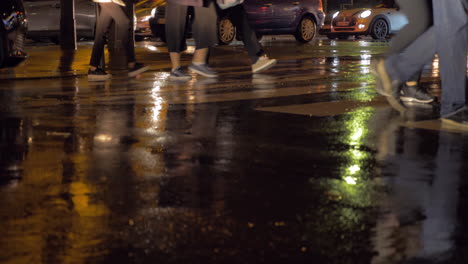 People-on-pedestrian-crosswalk-at-rainy-night-in-city-Paris-France