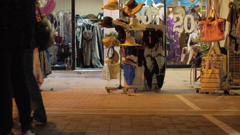 Night-street-with-people-passing-by-clothing-shop