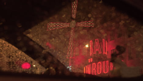 Moulin-Rouge-night-view-through-wet-car-window-Paris