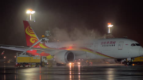 Aircraft-of-Hainan-Airlines-being-de-iced-before-the-night-flight