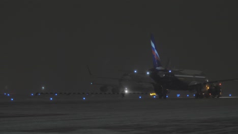 Cargo-Boeing-747-and-Aeroflot-aircraft-in-airport-at-winter-night