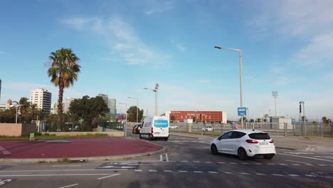 Cars-Driving-Fast-in-Mar-Bella-Beach-Avenue-Barcelona-Spain-Skyline-El-Poblenou