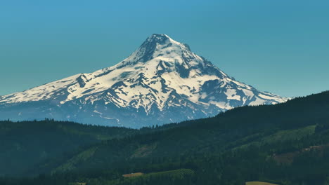 Aerial-telephoto-shot-of-the-snowy-Mount-Hood-mountain,-summer-in-Oregon,-USA