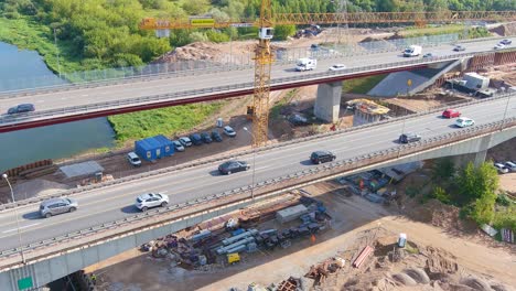 Industrial-crane-in-construction-site-of-middle-A1-bridge-in-Kaunas,-aerial-view