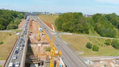 Construction-of-middle-A1-highway-road-bridge-in-Kaunas-over-river-Neris,-aerial-view