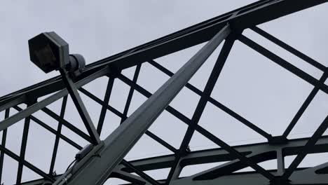 Steel-supports-and-struts-of-a-metal-device-with-an-old-lantern-of-the-Hohenzollern-Bridge-in-Cologne