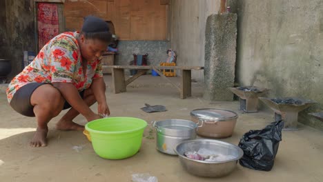 African-lady-working-in-outdoor-village-kitchen-preparing-tasting-fufu-traditional-ghana-street-food