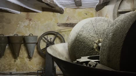 Workshop-with-large-stone-wheel-and-old-equipment-for-pressing-olive-oil-in-France