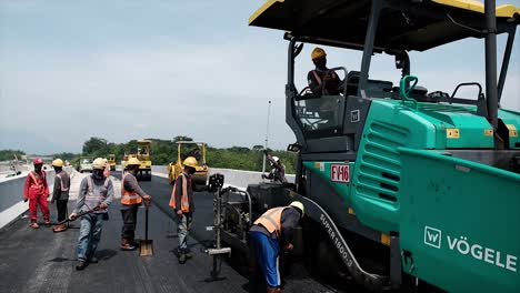 Compressing,-compacting,-leveling-and-smoothing-the-asphalt-road-surface-using-a-Tyre-Roller,-tandem-roller-and-Asphalt-Paver-Finisher