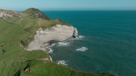 Aerial-drone-view-of-wild-and-rugged-Cape-Farewell-headland-with-dramatic-steep-cliff-coastal-landscape-in-South-Island-of-New-Zealand-Aotearoa