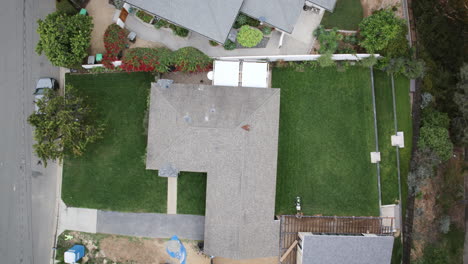 Top-down-aerial-timelapse-of-a-man-mowing-his-backyard