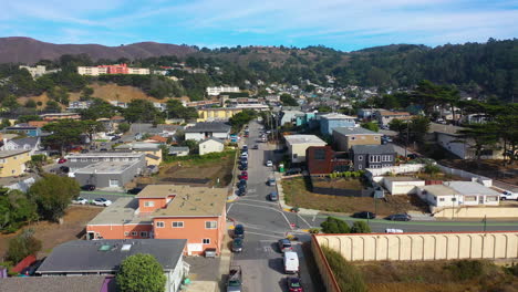 Aerial-view-low-over-streets-of-Pacifica-city,-sunny-day-in-California,-USA
