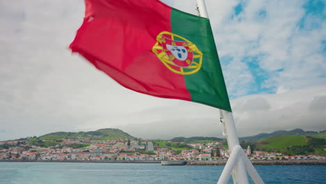 Close-up-shot-of-Portuguese-flag-waving-in-the-back-of-the-boat