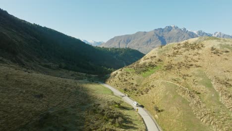 Aerial-view-of-remote-scenic-road-through-rugged-landscape-to-hidden-Moke-Lake-in-Otago,-South-Island-of-New-Zealand-Aotearoa