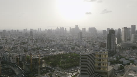Aerial-video-flying-over-downtown-Tel-Aviv-during-the-sunrise-haze-in-the-morning