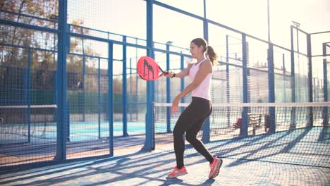 Murcia,-Spain,-November-23,-2023:-Young-sportswoman-and-man-couple-playing-padel-tennis-in-slow-motion