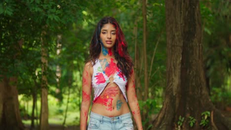 A-young-girl,-her-body-painted-with-vivid-colors,-stood-out-in-the-tropical-beauty-of-the-park
