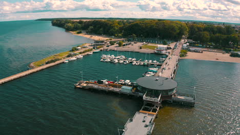 Aerial-shot-of-drone-flying-above-Puck's-bay-in-Poland-with-pier-in-the-background