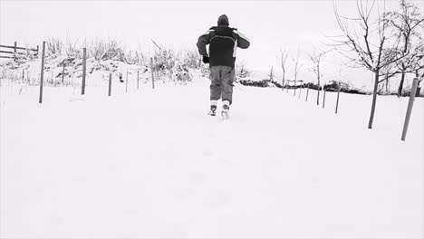 running-through-snow-on-a-winter's-day-with-people-stock-footage-stock-video