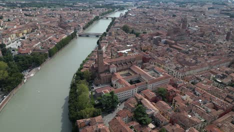 Aerial-shot-of-the-dense-city-Lazize-Verona-with-antique-architecture-with-a-river-flowing-in-middle