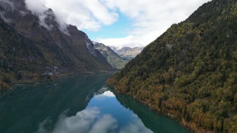 Zoom-Out-shot-of-great-lake-Klöntalersee-Glarus-Switzerland-located-in-between-the-dense-forest