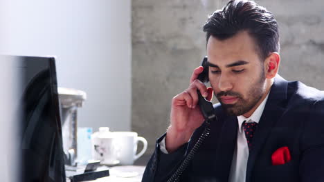 Young-Hispanic-businessman-using-phone,-close-up