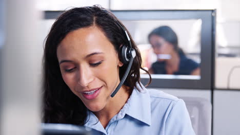 Young-mixed-race-woman-working-in-a-call-centre
