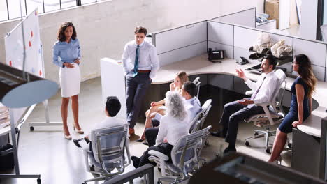 Female-manager-using-whiteboard-in-a--meeting,-elevated-view