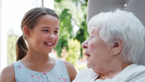 Enkelin-Sitzt-Und-Redet-Mit-Großmutter-Während-Eines-Besuchs-Im-Altersheim