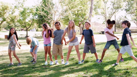 Group-Of-Children-With-Friends-In-Park-Dancing-And-Flossing