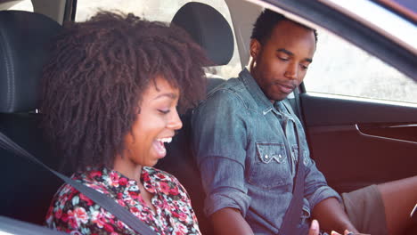 Black-couple-checking-map-on-smartphone-in-car,-close-up
