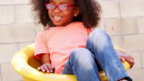 Young-black-girl-spinning-in-school-playground,-close-up