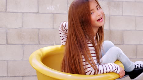 Young-Asian-girl-spinning-in-school-playground,-close-up