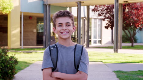 Smiling-mixed-race-schoolboy-walking-to-camera-outside