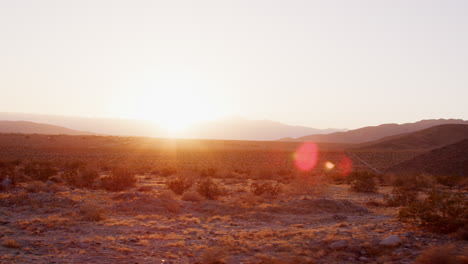 Desert-landscape-at-sunset-seen-from-moving-vehicle