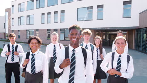 Portrait-Of-Smiling-Male-High-School-Students-Wearing-Uniform-Outside-College-Building