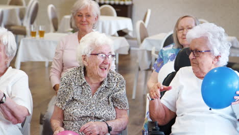 Group-Of-Seniors-Enjoying-Fitness-Class-In-Retirement-Home
