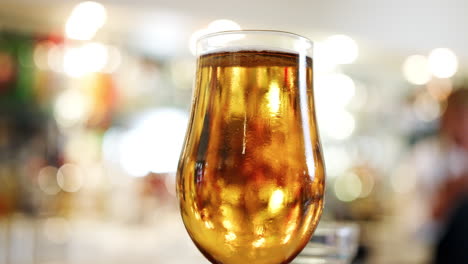 Close-Up-Of-Glass-Of-Beer-On-Bar-Counter