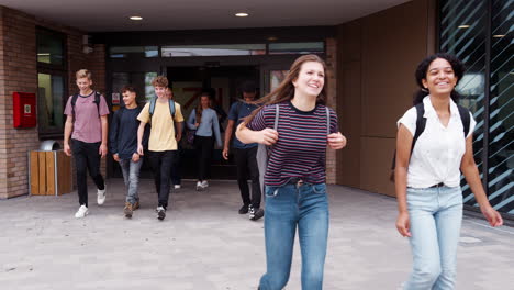 Group-Of-High-School-Students-Walking-Out-Of-College-Building-Together
