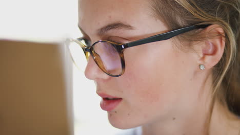 Close-Up-On-Face-Of-Female-Teenage-Artist-Working-Behind-Easel