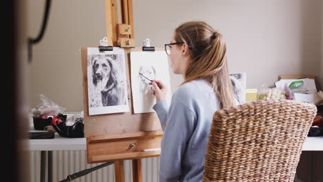 View-Through-Door-Of-Female-Teenage-Artist-At-Easel-Drawing-Picture-Of-Dog-In-Charcoal